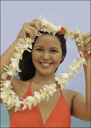 Hawaiian girl giving a lei to viewer