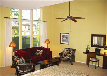 Hale Wailele's Living Room with Waterfall and Pool Views Hawaiian decorated living room off the dining room with ceiling fan, comfy microsuede sleeper sofa and 2 more upholstered chairs around a coffee table